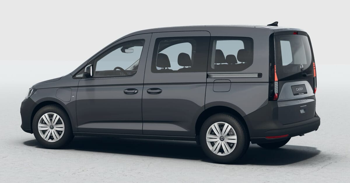 Seitenansicht eines grauen Volkswagen Caddy eHybrid auf neutralem Hintergrund.
